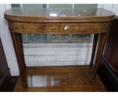 A 19th century cross-banded mahogany fold over card table, with inlaid decoration, raised on tapered legs with spade feet, W9