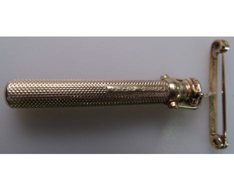 A 9ct gold engine turned propelling pencil with cover, by Samuel Mordan &amp; Company, and a 15ct gold safety pin fob