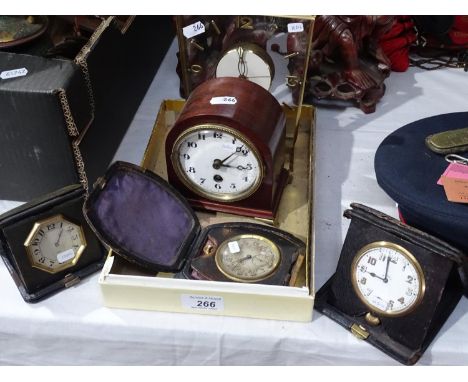 A Tiffany 8-day travel clock, and 2 similar, an 8-day mahogany time piece, and a Swiza 8-day clock