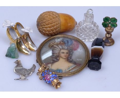 An oval portrait miniature, a thimble cased in vegetable ivory acorn, a miniature bottle, an agate seal etc