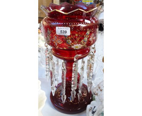 A ruby glass table lustre with enamelled and gilded decoration, height 14.5"