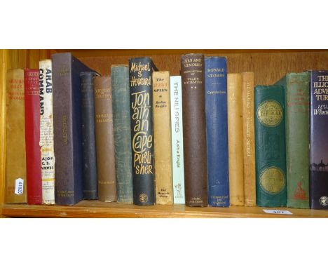 A shelf of various hardback books