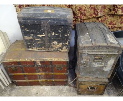 A large dome-top metal and wood-bound travelling trunk, 2 small dome-top wood and metal-bound travelling trunks, and another 