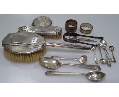An Art Deco engine turned silver-backed dressing table brush, silver napkin rings, teaspoons etc, 5.2oz weighable silver, a s