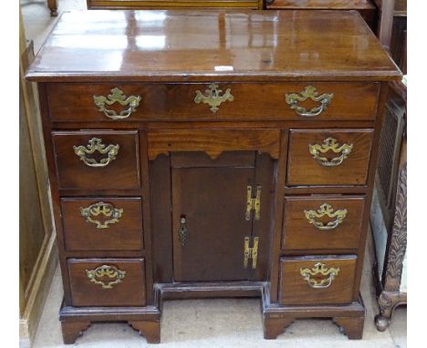 An 18th century mahogany Queen Anne style writing desk, with a single frieze drawer, a recessed panelled cupboard, flanked by
