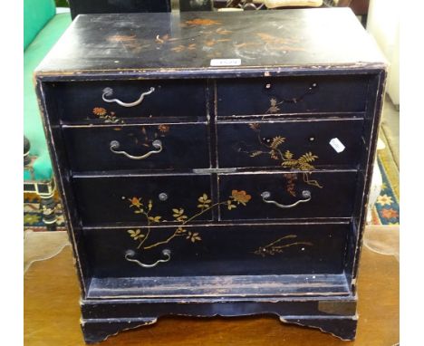 An Oriental black lacquered table-top cabinet, fitted with 7 short drawers, on bracket feet, W46cm, H50cm