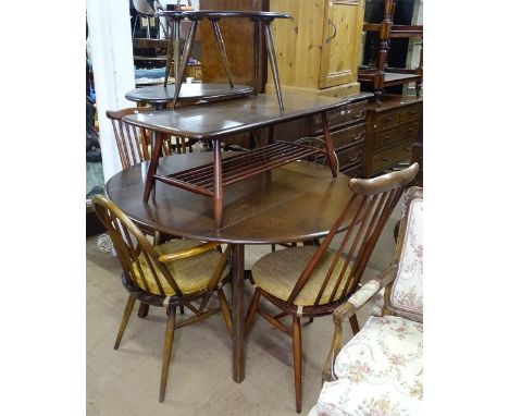 A dark elm Ercol drop leaf kitchen table, together with a pair of Ercol arch-top elbow chairs, and a pair of Ercol side chair