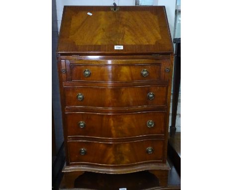 A reproduction cross-banded mahogany bureau of narrow size, with 4 serpentine-front drawers, on bracket feet, W57cm