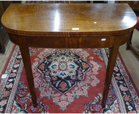 A 19th century mahogany fold over card table, with banded decoration, raised on square tapered legs and spade feet, W91cm