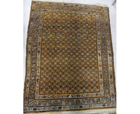 A Persian rug, the central panel with repeating stylised floral decoration on an orange ground within an orange, brown and ta