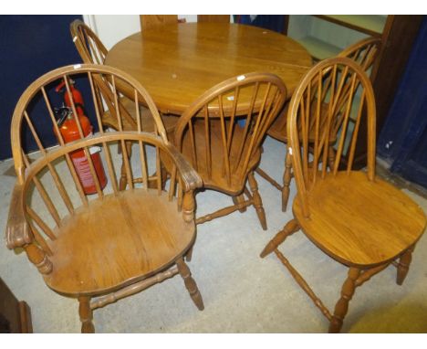 A Canadian oak circular dining table on central pedestal, and a set of five matching stick back kitchen chairs