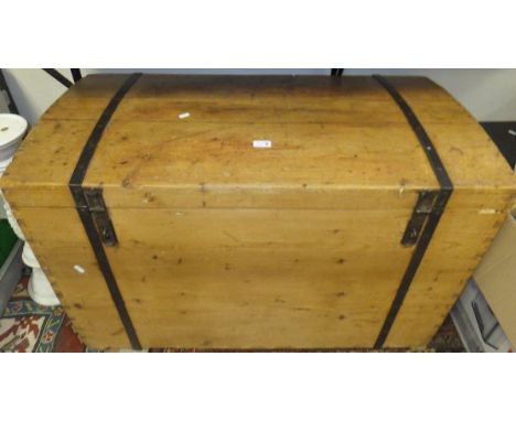 A large pine dome top trunk with wrought iron fitments and handles