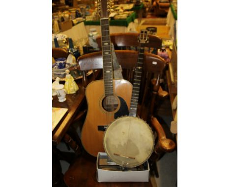 A Flights banjo with vibrator, Patent 18758, No'd 6382, a Harmony Model H6860-12 twelve string acoustic guitar, a Larry Adler