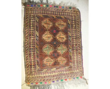 A Beluche rug, the central panel with two medallions on an orange ground, within an orange, burgundy and brown geometric patt