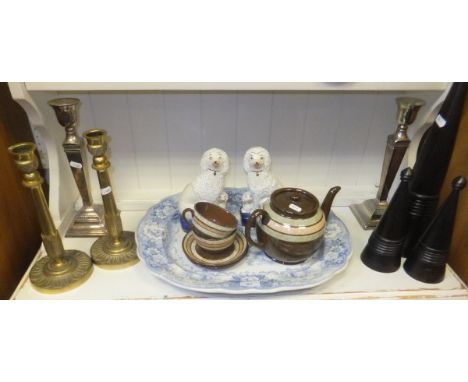 A 19th Century blue and white transfer decorated pottery meat plates, a pair of Staffordshire type poodle ornaments, a Sadler