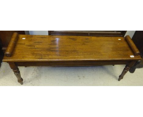 An oak window bench on turned legs