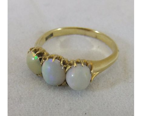 A 14ct gold and opal set dress ring CONDITION REPORTS Ring size sits between "Q" and "R".  Opals are varying depth.  One appe