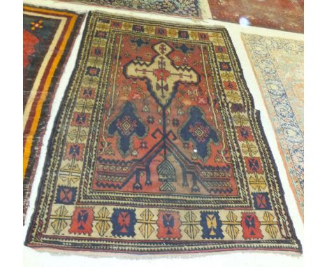 A Persian rug, the tree of life style decoration on a red ground within a cream, red, blue and yellow patterned border, 200 c