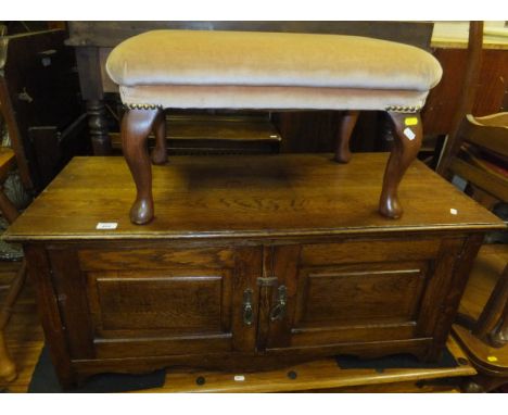 An oak rectangular low two-door cupboard, and a pink upholstered rectangular stool togeather with brass reading lamp with cra