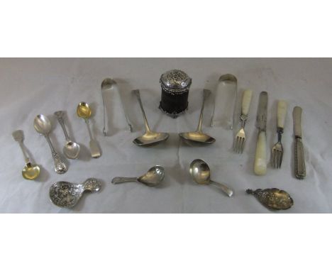 A box containing various silver and white metal wares, to include three caddy spoons, sugar nips, pair of sauce ladles, torto