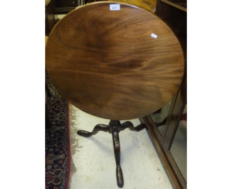 A mahogany tea table, the circular snap top on a turned pedestal to tripod base