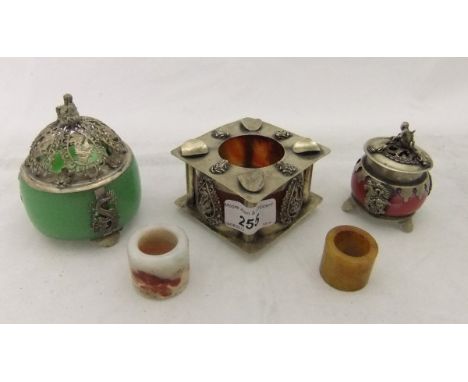 A Chinese white metal mounted ash tray, two white metal mounted perfume pots, a jade archery ring, and a hardstone archery ri