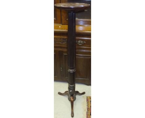 A Victorian mahogany torchere stand, the circular dished top on a turned and fluted pedestal to cabriole tripod base (bed pos