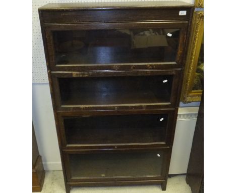 A stained oak four section Globe Wernicke style book case