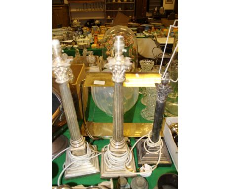 A pair of modern plated Corinthian column table lamps, another similar smaller lamp, and a brass desk lamp