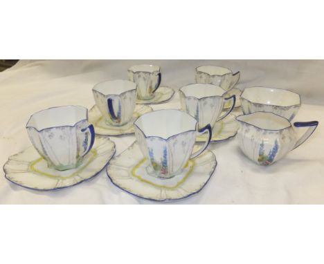 A collection of Shelley coffee wares decorated with tall trees and hollyhocks, to include six cups and saucers, cream jug and