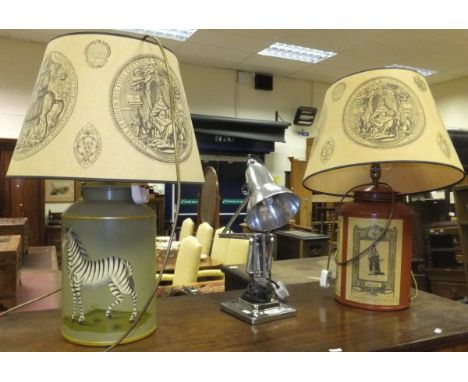 A hand-painted tin table lamp with zebra decoration by Woolpit Interiors, another with applied printed decoration of Kings of