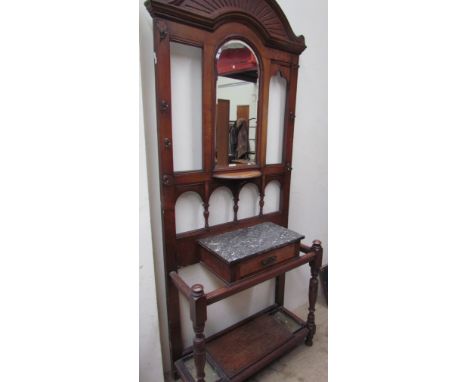 An Edwardian oak hall stand with a central mirror shelf, hook, marble top etc