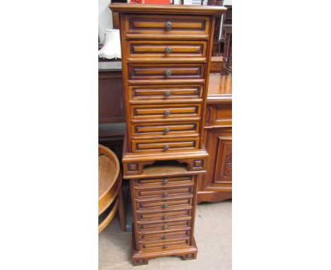 A pair of modern bedside cabinets each set with seven drawers on bracket feet