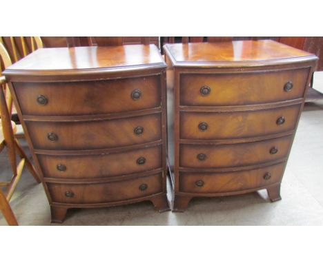 A pair of reproduction mahogany chests each with four graduated drawers on splayed bracket feet