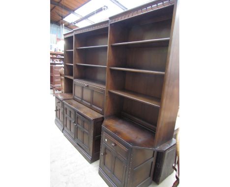 An Ercol dark elm and beech three section wall unit