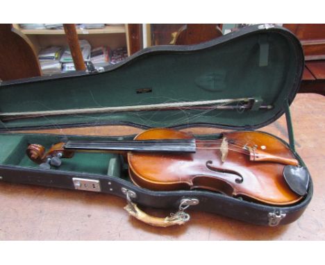 A violin and bow, bears a label, imported by Leslie Sheppard, cased, 59cm long overall, back including button 37.5cm long