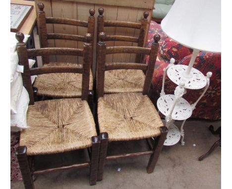 A set of four dining chairs with bar backs and rush seats together with a cast iron three tier standard lamp