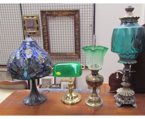 A Tiffany style table lamp together with another table lamp, an oil lamp and a desk lamp
