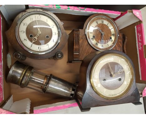 Three mid-century oak cased mantle clocks together with a steel and brass miner's lamp (4). 