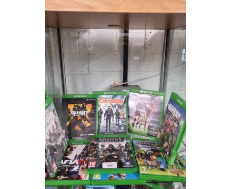 Shelf of Xbox one games . 