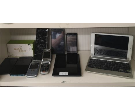 Shelf of mobile phones tablets etc . 