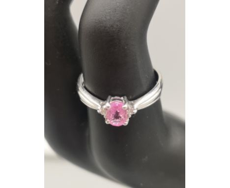 9ct white gold pink stone ring set with clear stone shoulders. 