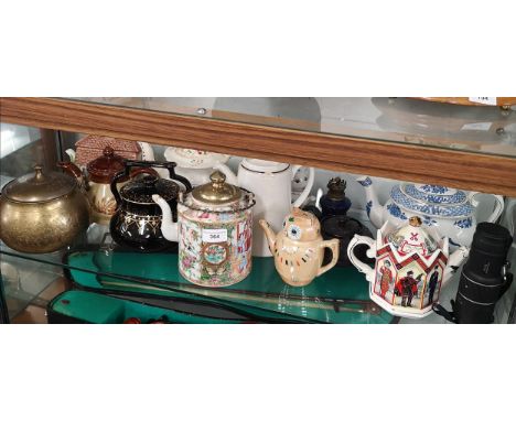 Shelf of Tea pots etc . 