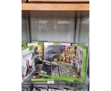 Shelf of xbox 360 games . 