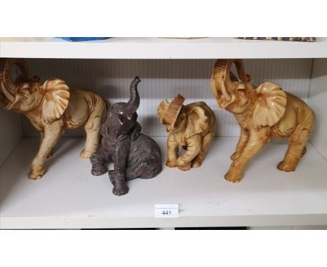 Shelf of Resin Elephant figures . 