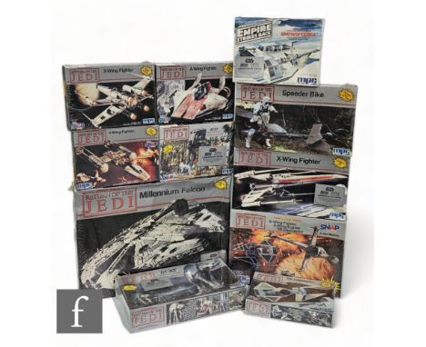 A collection of MPC / ERTL Star Wars plastic model kits, comprising Millennium Falcon, AT-ST, TIE Interceptor, X-wing (8932),