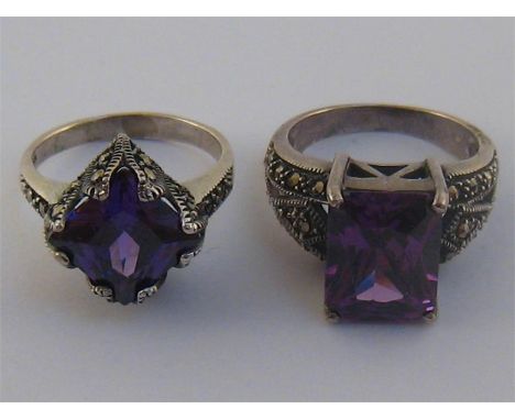 Two silver, marcasite and purple paste rings, respectively set with a square and a rectangular cut stone, each stamped ‘925’,