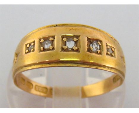 A late Victorian 15 carat gold and rose cut diamond ring, set to the centre with five graduated gypsy set rose cuts, between 