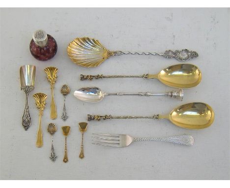 A pair of Victorian silver-gilt serving spoons with spirally fluted stems and finials modelled as bust of a Classical youth w