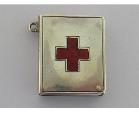 An Edwardian silver stamp case of book form, enamelled to cover with the red cross emblem, by Sydney & Co., Birmingham, 1905,